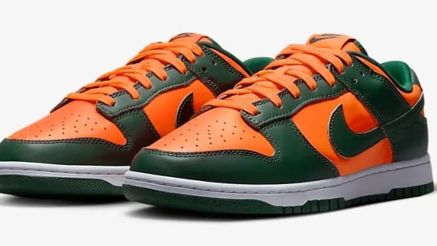 Side view of green and orange Nike Dunk shoes.